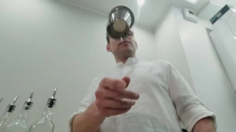 Making alcoholic cocktail. Bartender throws jigger and does not catch Stock Footage 134035351
