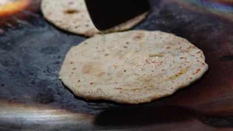 Making Aloo Paratha on a Griddle, Adding Oil with a Spatula Skillfully in Delhi. Stock-Footage 254807402