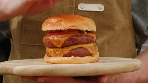 Making American fat smash burger with fresh tomatoes and cheese on grill close Stock Footage 270020754