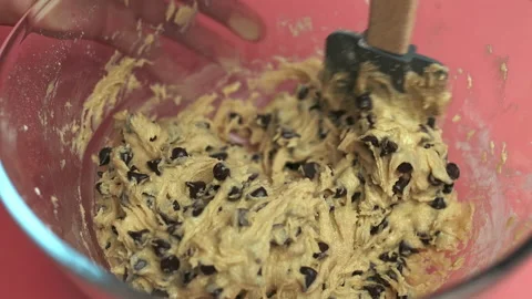 Making and Mixing Chocolate Chip Cookies dough in a transparent glass bowl in 4K Stock Footage 135700859