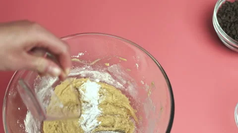 Making and mixing Chocolate Chip Cookies dough in a glass bowl in 4k. Stock Footage 135701161
