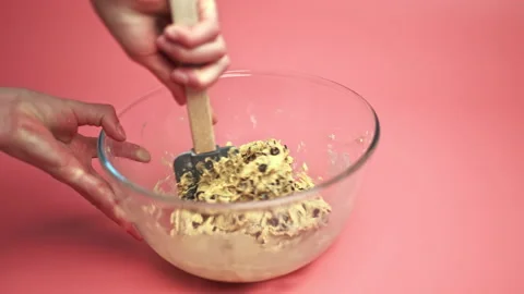 Making and Mixing Chocolate Chip Cookies dough in a transparent glass bowl in 4K Stock Footage 135701985