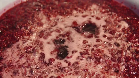 Making appetizing raspberry jam at home on the stove close-up. Stock Footage 215994051