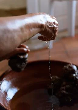Making Argan Oil by Hand - squeezing pulp to release oil Stock Photos