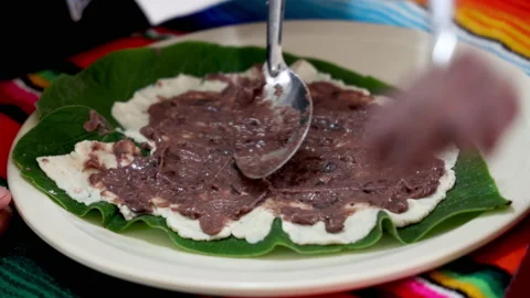 Making Authentic Black Bean Tamales with the Sacred Leaf Stock Footage 185604174