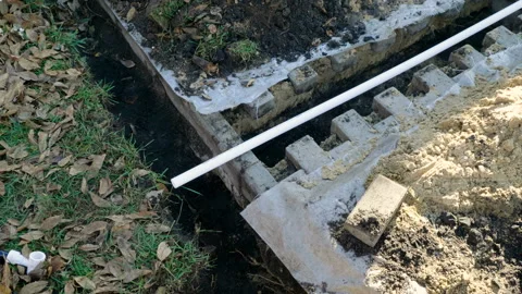 Making of automatic system for watering plants and lawn in the garden. 4K Stock Footage 106942213