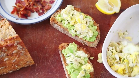 Making avocado toast with eggs and bacon Stock Footage 77811038