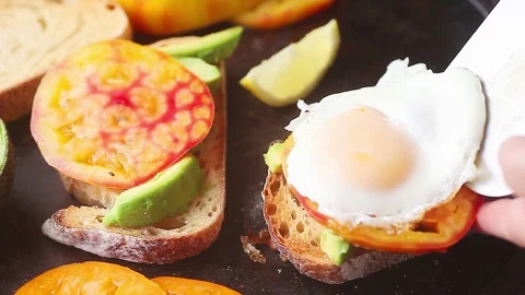 Making avocado toast with tomato and fried egg Stock Footage 78167236