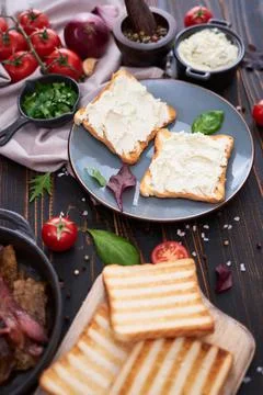 Making bacon and cream cheese sandwich - ingredients on wooden table Stock Photos