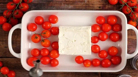 Making baked feta pasta with cherry tomatoes, herbs and olive oil Stock Footage 242524424