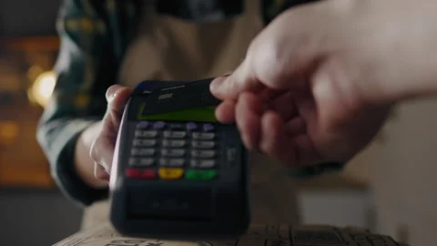 Making, the baker prepares The baker gives a terminal for payment, Prepared Stock Footage 243002043