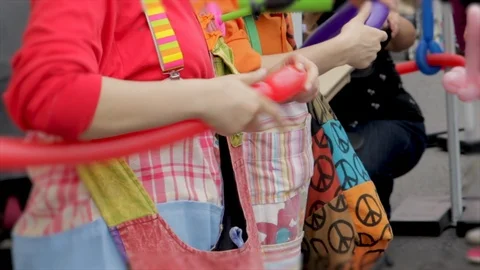 Making balloon dog animals close up. Clown at outdoor circus festival creating a Stock Footage 109074173