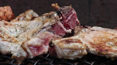 Making a barbecue outdoors, pork chops on grill at a party or picnic Stock Footage 41267846
