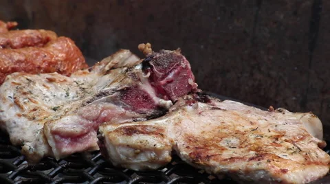 Making a barbecue outdoors, pork chops on grill at a party or picnic Stock Footage 41267903