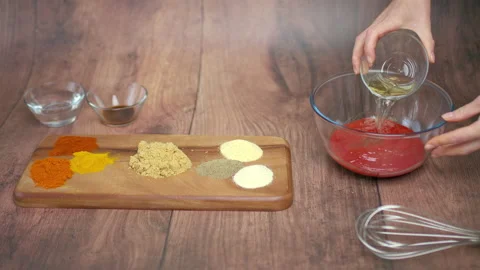 Making barbecue sauce by adding different ingredients, spices in a bowl in 4K Stock Footage 135990187