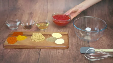 Making barbecue sauce by adding different ingredients, spices in a bowl in 4K Stock Footage 135991368