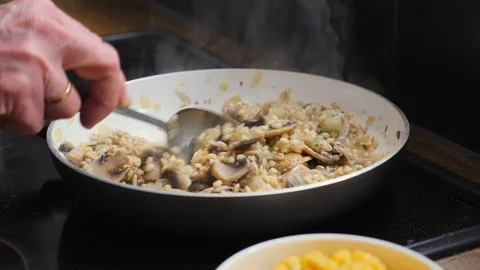 Making barley risotto with mushrooms Stock Footage 88110985