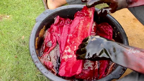 Making batik tie and dye. Person dissolving cloth into chemicals Stock Footage 202434742