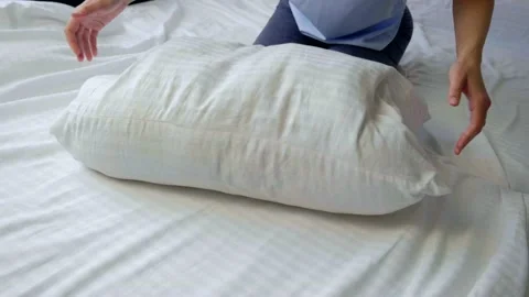 Making bead and beating pillows in slowmotion Stock Footage 131880386