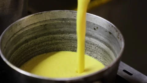 Making beaten yellow corn in a metal container. Stock Footage 147273439