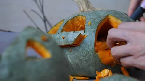 Making beautiful autumn lantern from pumpkin, scooping out all the pulp from Stock Footage 250236286
