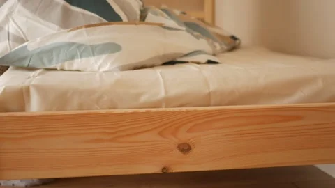 Making a bed with fresh linens in a simple bedroom Stock Footage 322717599