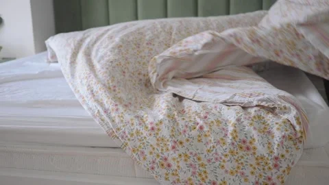 Making a bed with a fresh sheet in a bedroom Stock Footage 339519294