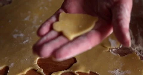 Making bell shape cookies from a dough with a cookie cutter tool Stock Footage 151634059
