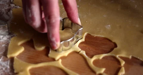 Making bell shape cookies from a dough with a cookie cutter tool Stock Footage 151634113