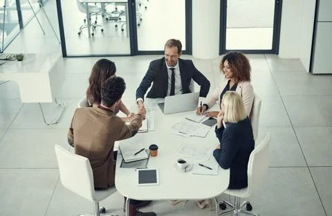 Making binding business commitments. two businessmen shaking hands during a Stock Photos