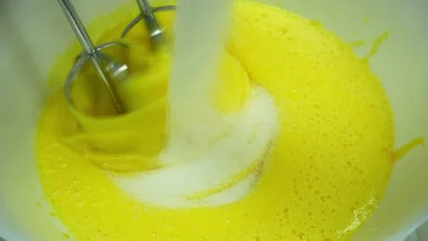 Making a bisquit. Adding sugar to eggs Stock Footage 233518672