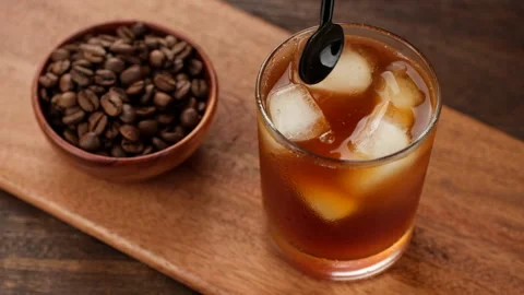 Making black coffee with ice, close up. Coffee drinks concept Stock Footage 243079309