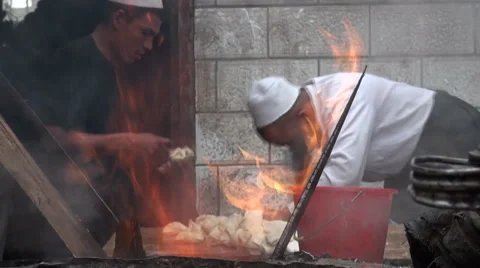 Making bread behind fire, tandoori oven, China Video stock 4481934
