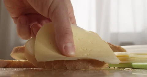 Making Bread with Cheese Sandwich at the Table in the Kitchen Video stock 148643604