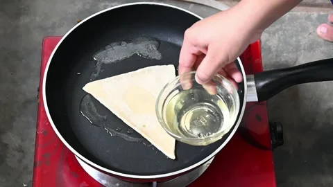 Making bread in fry-pen or pide dough by close up female hands in pastry kit Stock Footage 209134163