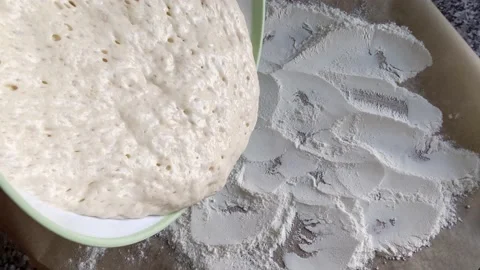 Making bread at home, dropping dough with yeast on baking sheet Stock Footage 238726323