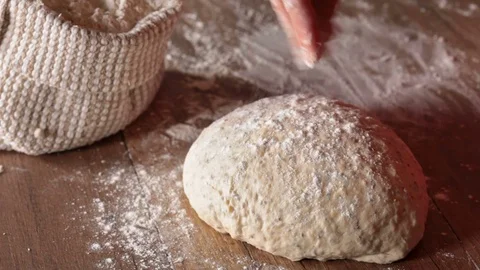 Making bread , kneading the dough, closeup Stock Footage 69990684