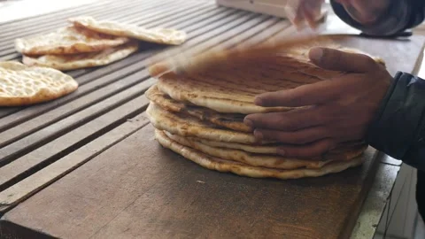 Making bread in a local bakery in the morning sun Видео 334093059