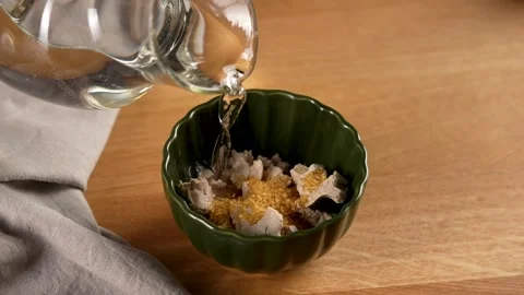 Making Bread - pour water from a glass jar over the yeast mixture Stock Footage 265886223