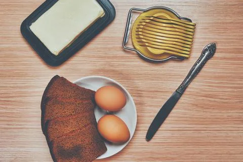 Making a breakfast sandwich, bread and butter and egg with egg cutting Stock Photos
