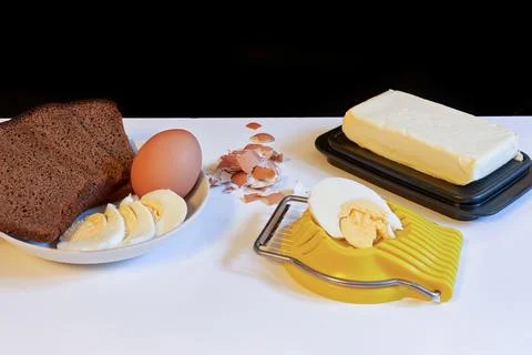 Making a breakfast sandwich, bread and butter and egg with egg cutting 스톡 사진