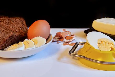 Making a breakfast sandwich, bread and butter and egg with egg cutting Stock Photos
