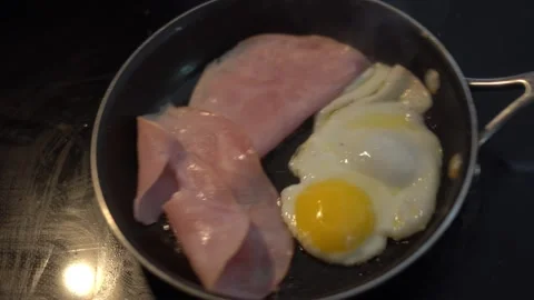 Making breakfast sandwich, cooking eggs, ham and egg sandwich, morning Stock Footage 262562612