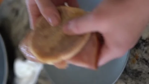 Making breakfast sandwich, cooking eggs, ham and egg sandwich, morning Stock Footage 262562637