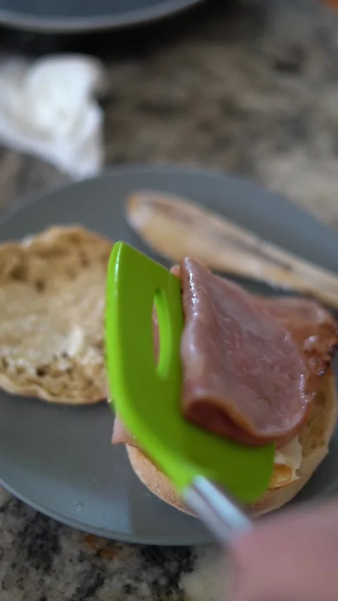 Making breakfast sandwich, cooking eggs, ham and egg sandwich, morning Stock Footage 262562669