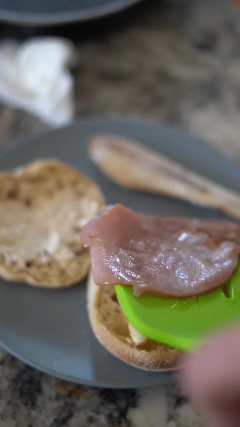 Making breakfast sandwich, cooking eggs, ham and egg sandwich, morning Stock Footage 262562682