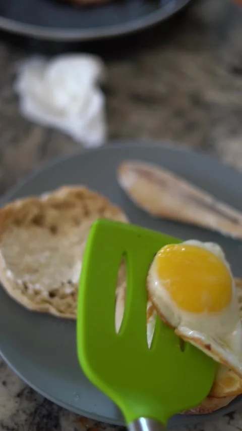 Making breakfast sandwich, cooking eggs, ham and egg sandwich, morning Stock Footage 262562684