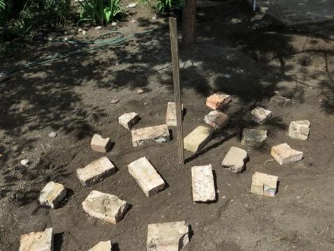 Making a brick base for an alpine garden mountain in the summer garden Stock Photos