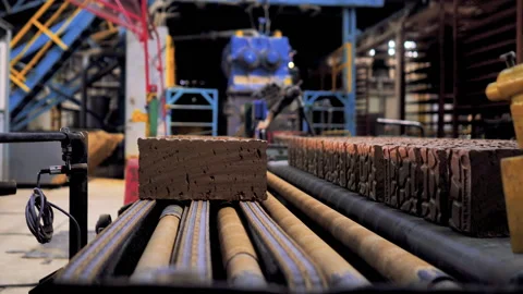 Making bricks on a conveyor belt Stock Footage 132776381