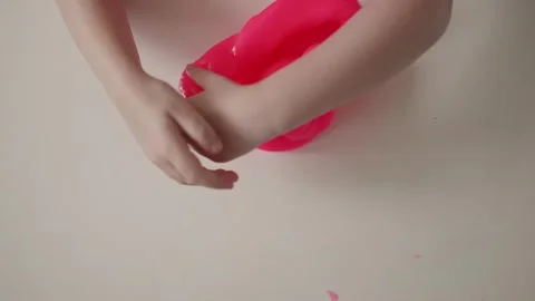 Making bright pink slime at home with simple ingredients and fun techniques for Stock Footage 341507407